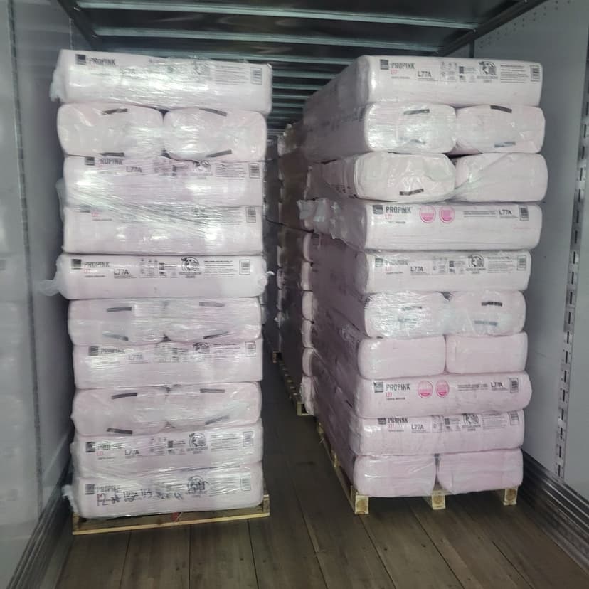 Pallets of pink fiberglass insulation loaded in a dry van trailer for a Curri building-materials freight haul