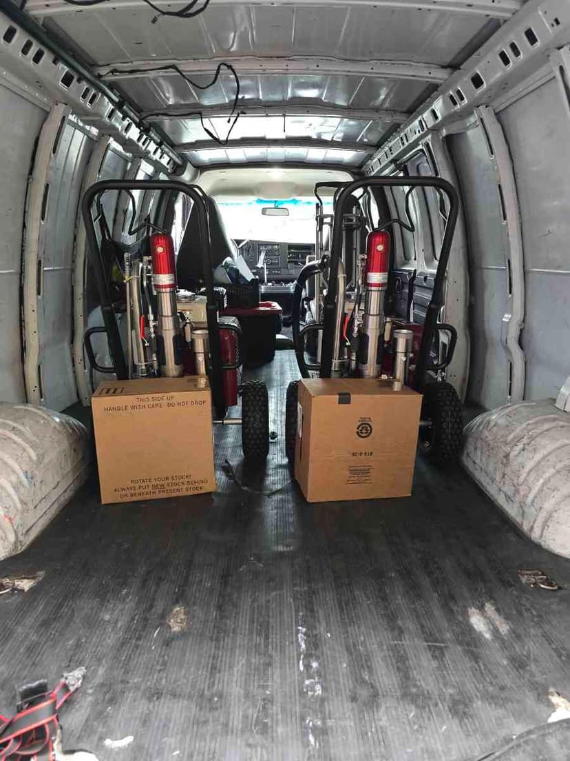 Cargo Sprinter Van interior loaded with paint sprayers and a wheeled cart for a Curri multi-stop supply run