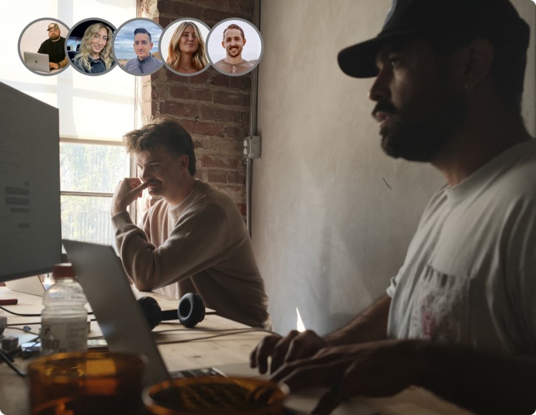 Curri LTL support specialists collaborating at laptops with a row of customer avatars — dedicated humans proactively resolving freight issues before customers feel them